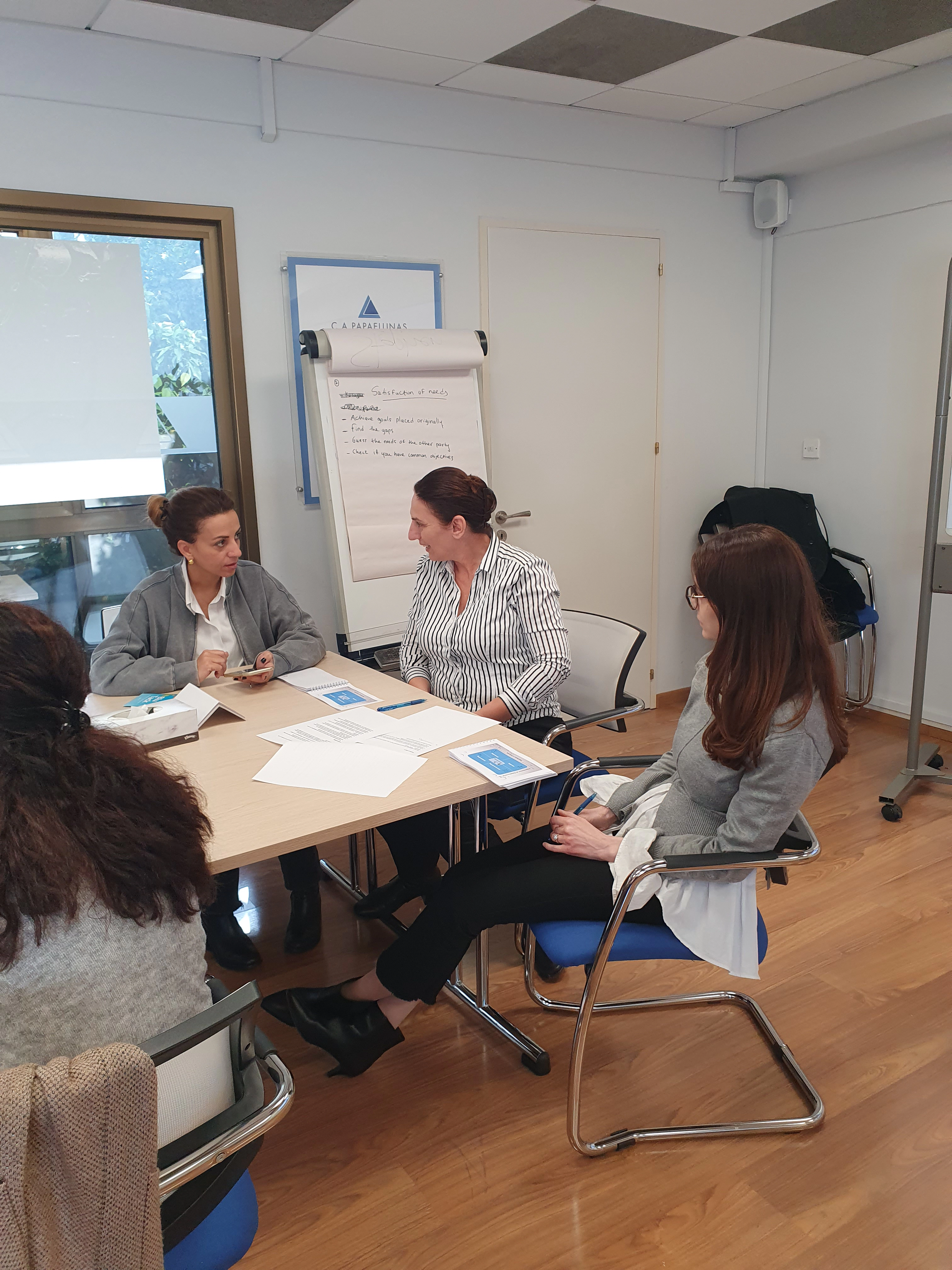 Diverse group of professionals negotiating together at a conference table.