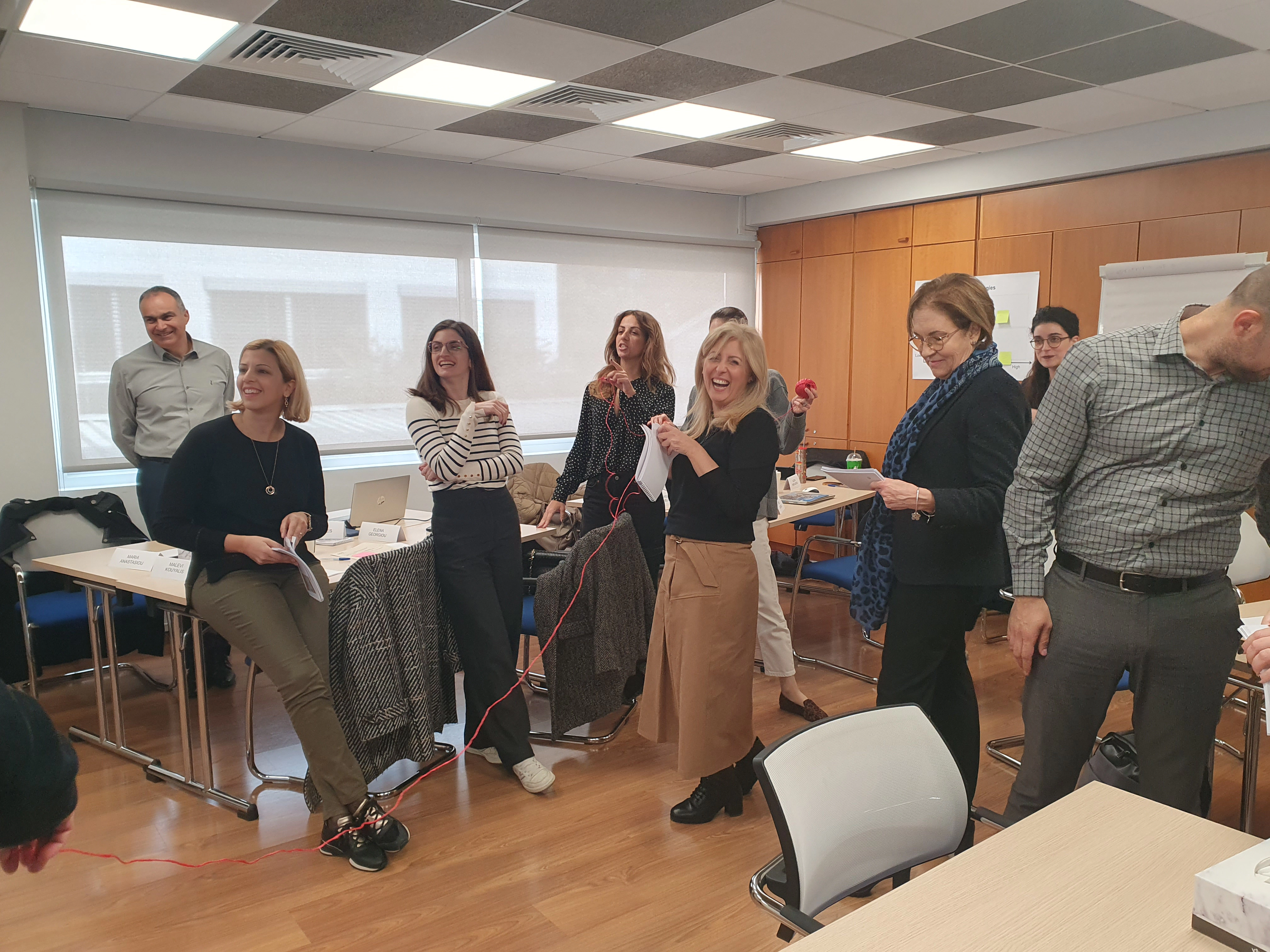 Team members enjoying an interactive sting activity designed to enhance confidence and strategic thinking in negotiation workshops..