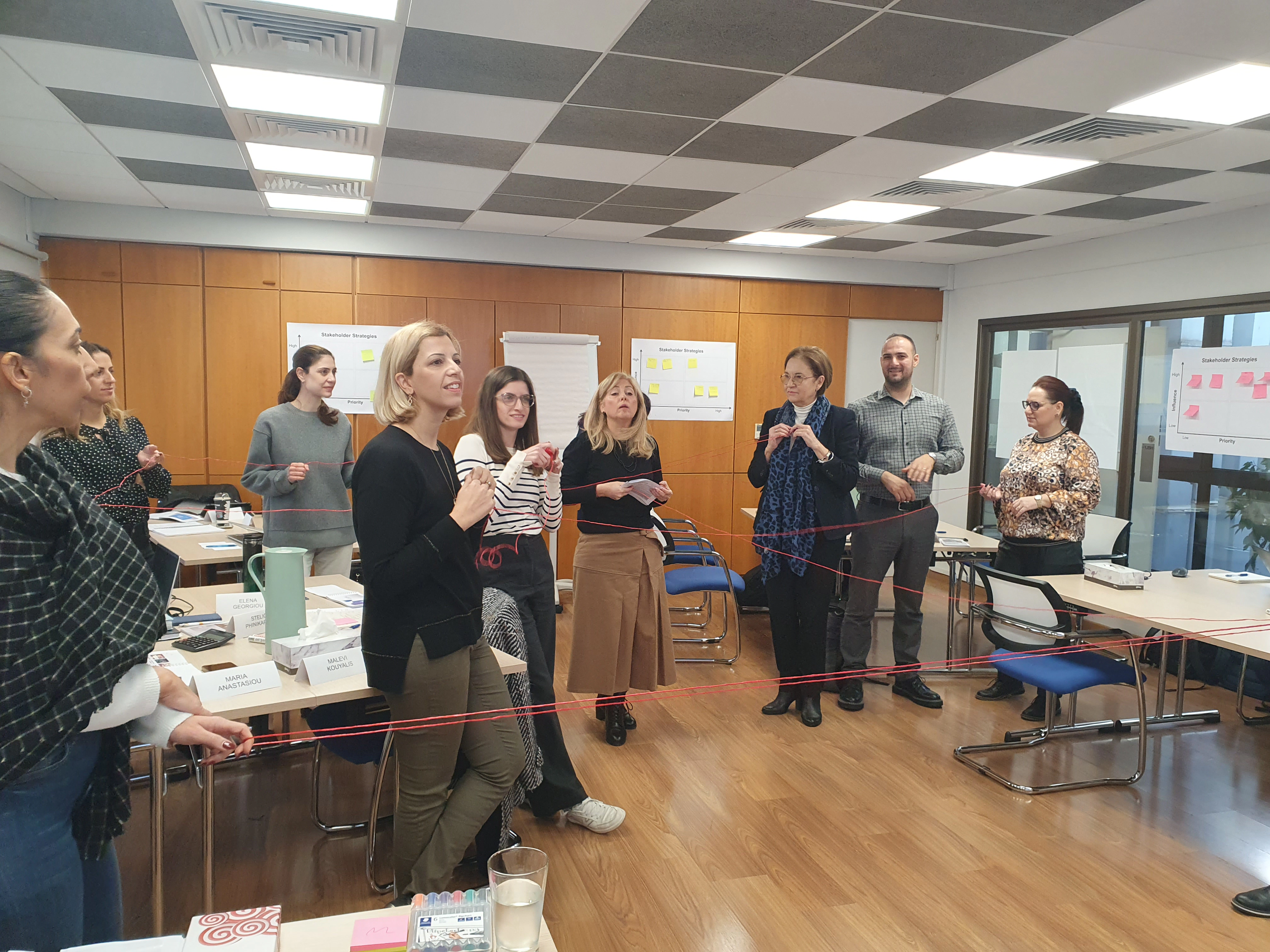 Participants taking part in a fun sting exercise during negotiation training to improve communication and persuasion skills.