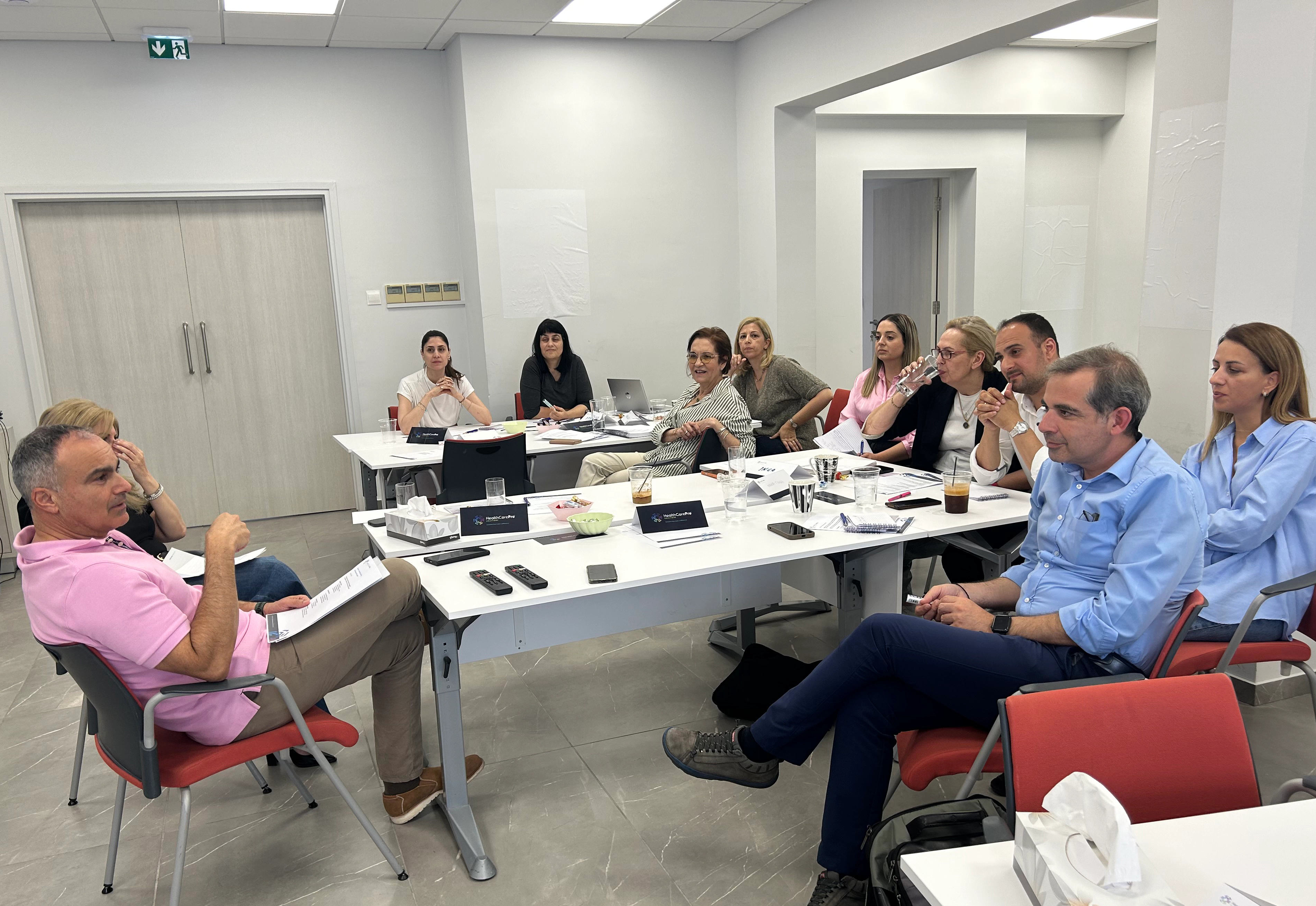 Training participants listening attentively during a pharmaceutical industry learning session.